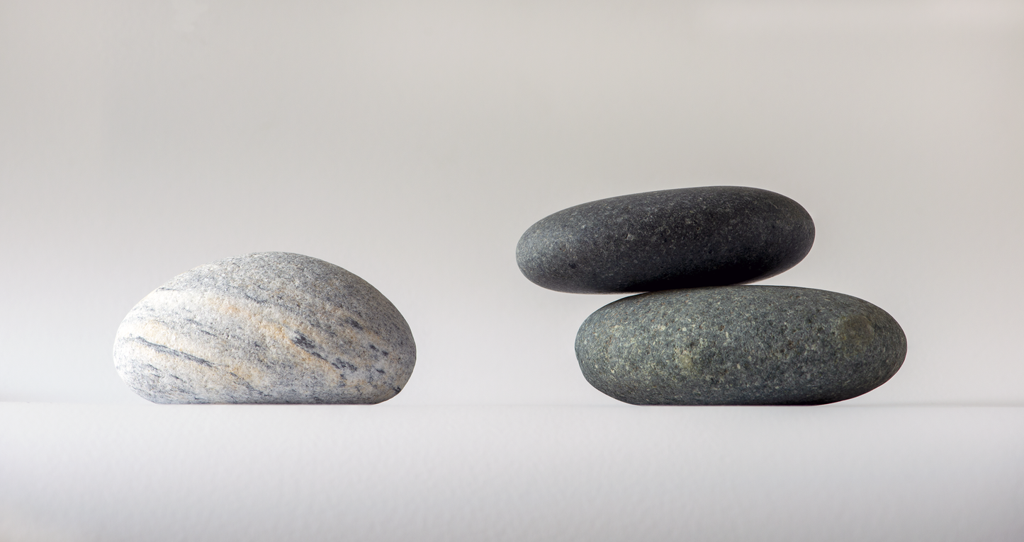 Three rocks on a white background